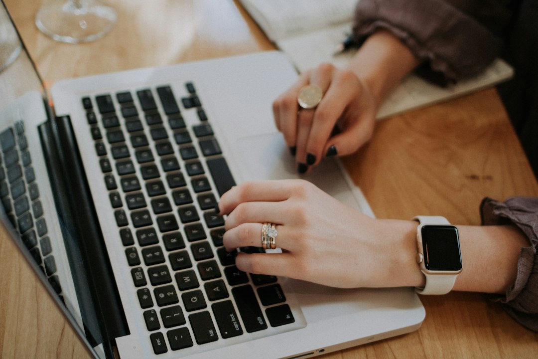 Person working on laptop representing local business marketing software